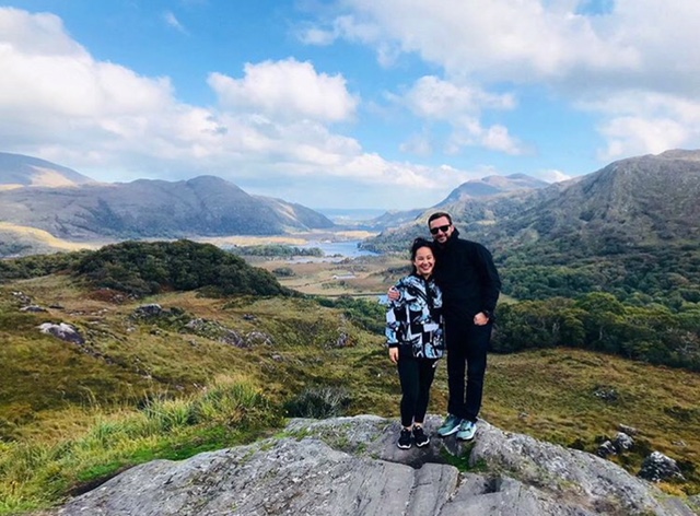 Chris and his wife on a rocky overlook above an Irish valley
